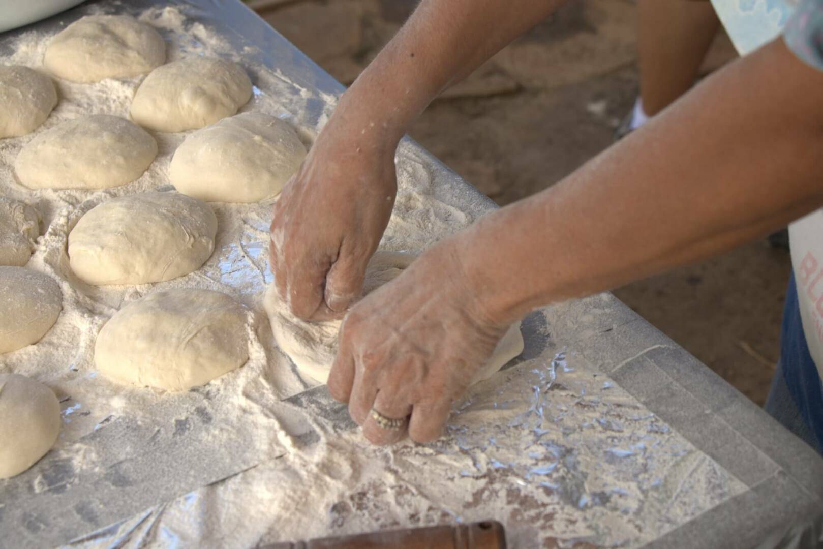 Person kneading balls dough