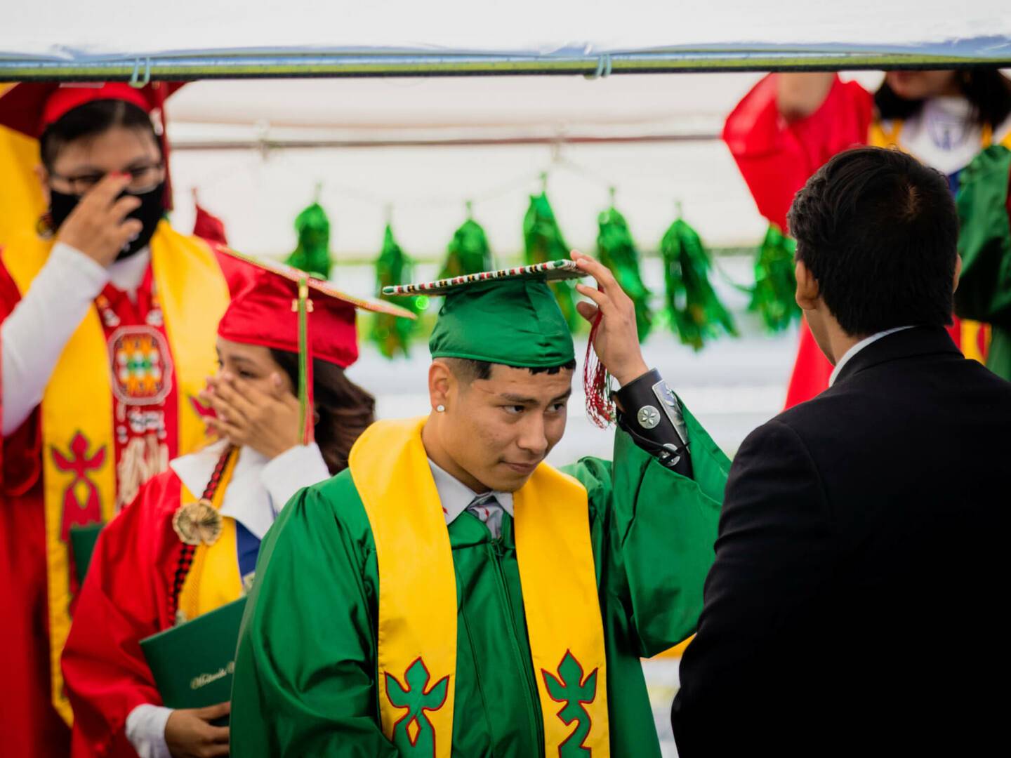 Boy holding his cap at the 2021 Meskwaki High School graduation