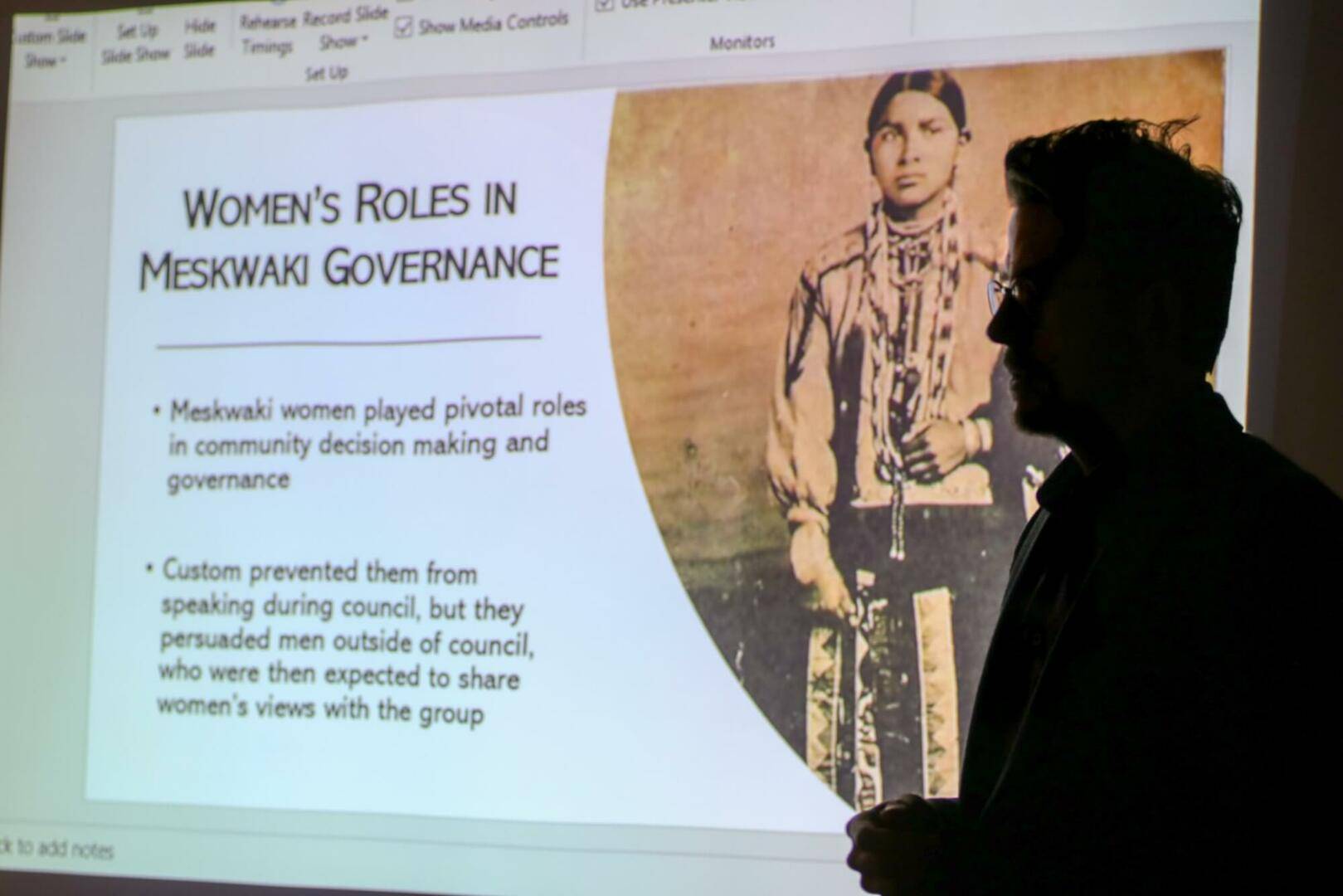 Man giving a presentation on women's roles in Meskwaki governance