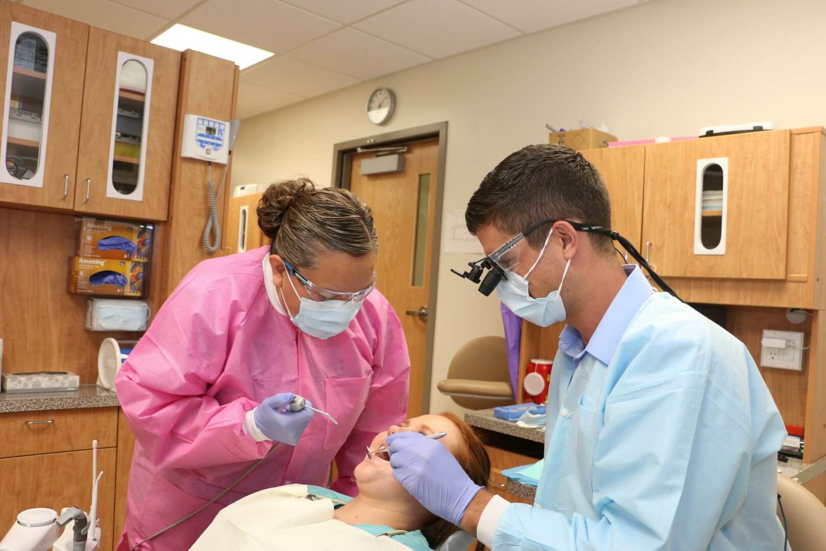 Dentist and his assistant working in patients mouth