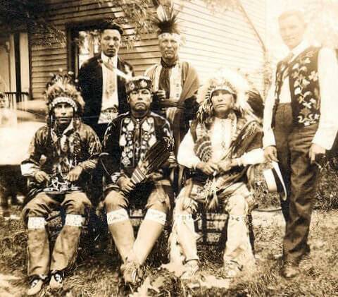 Vintage photo of a group of men in traditional tribal wear